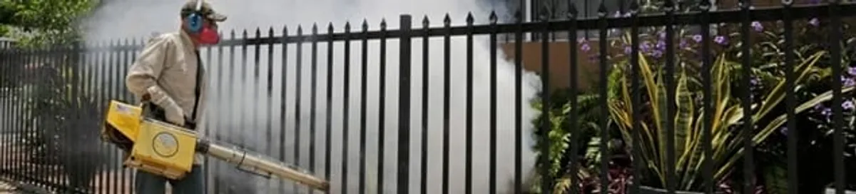 Mosquito control technician fogging a yard perimeter for mosquito reduction in Louisville, KY